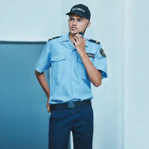 Security guard checking visitor ID at gate